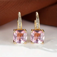 Goldene Ohrringe mit mystischem Steinkreis – Pink-Saphir